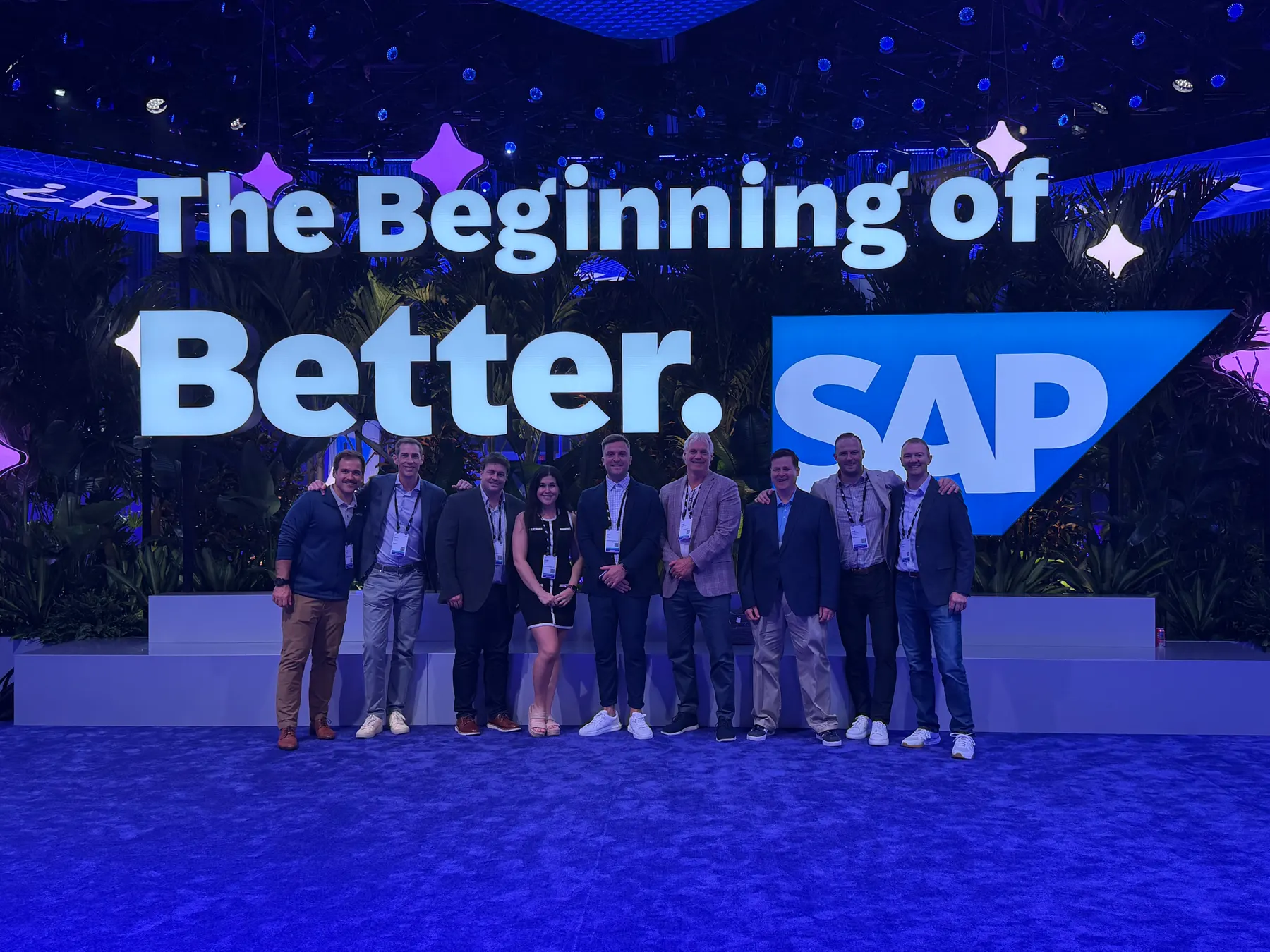 Mindset team members at an SAP conference, in front of conference signage