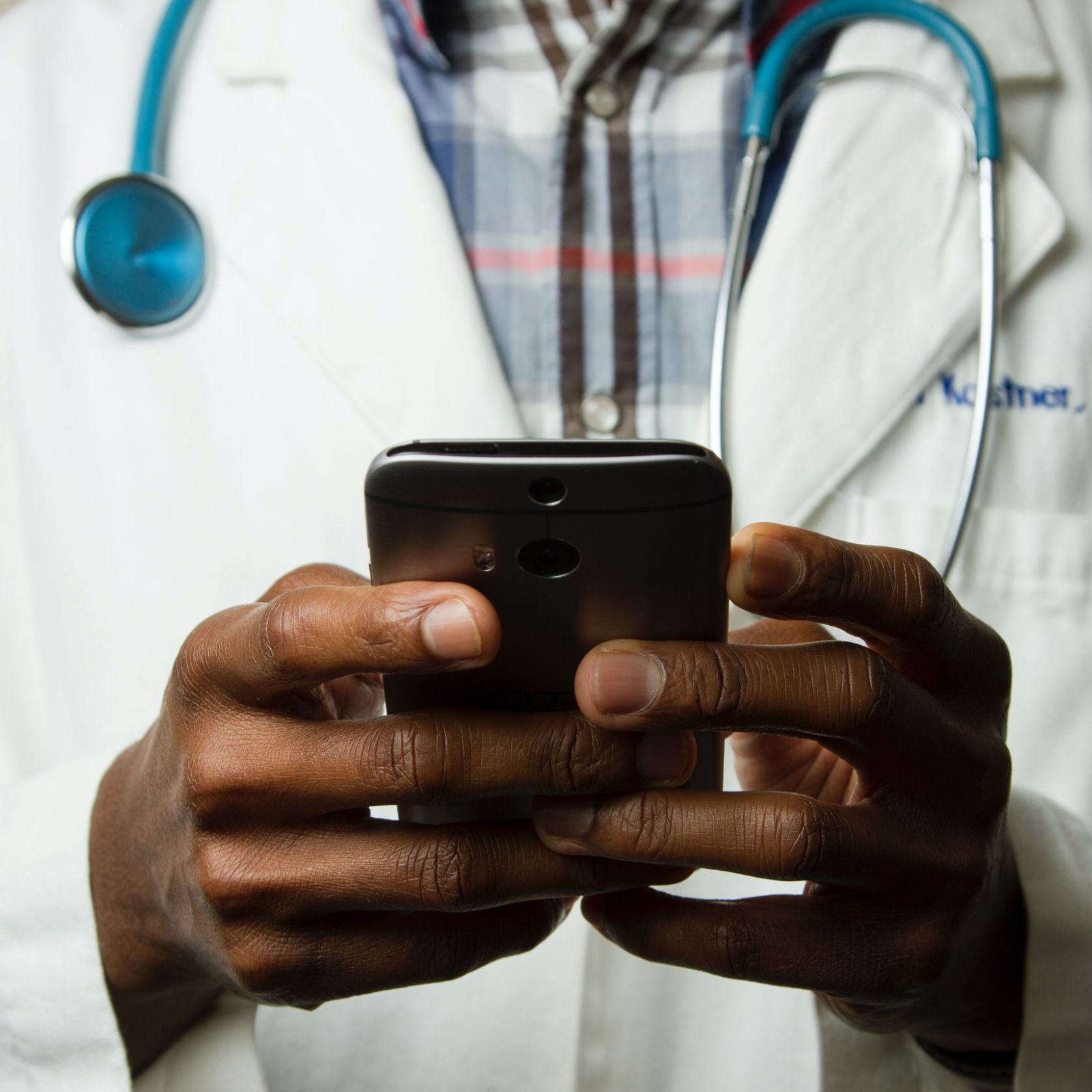 Close up of doctor's hands holding a mobile phone