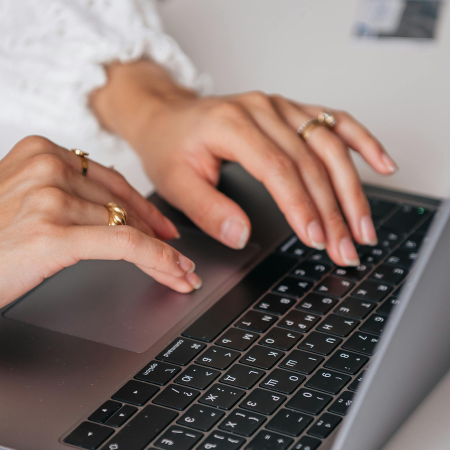 Professional typing on laptop keyboard for SAP BTP consulting and enterprise solutions development