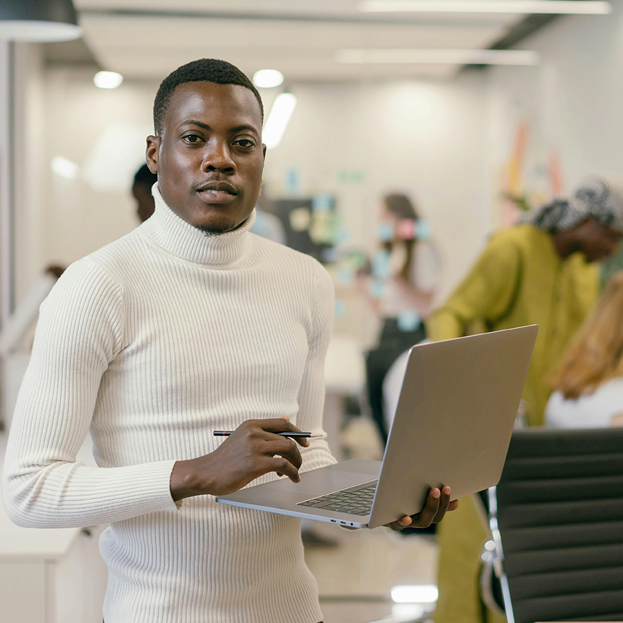 Professional consultant working on laptop in modern office discussing SAP BTP strategy and implementation