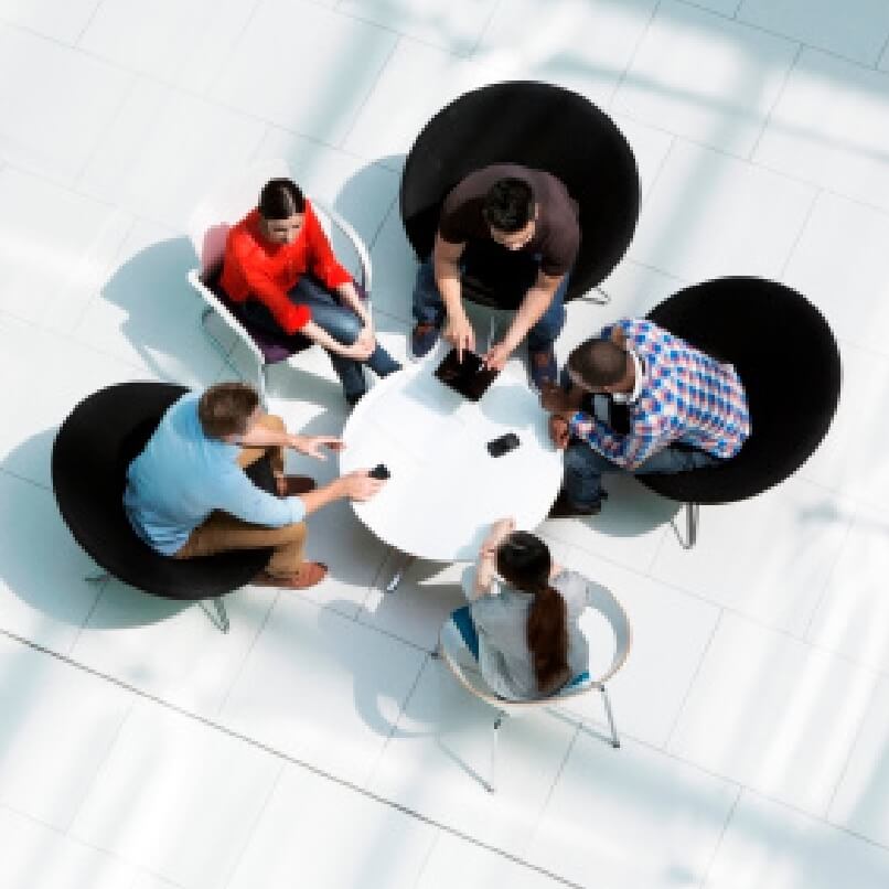 SAP consulting team collaborating around table discussing BTP strategy and implementation solutions