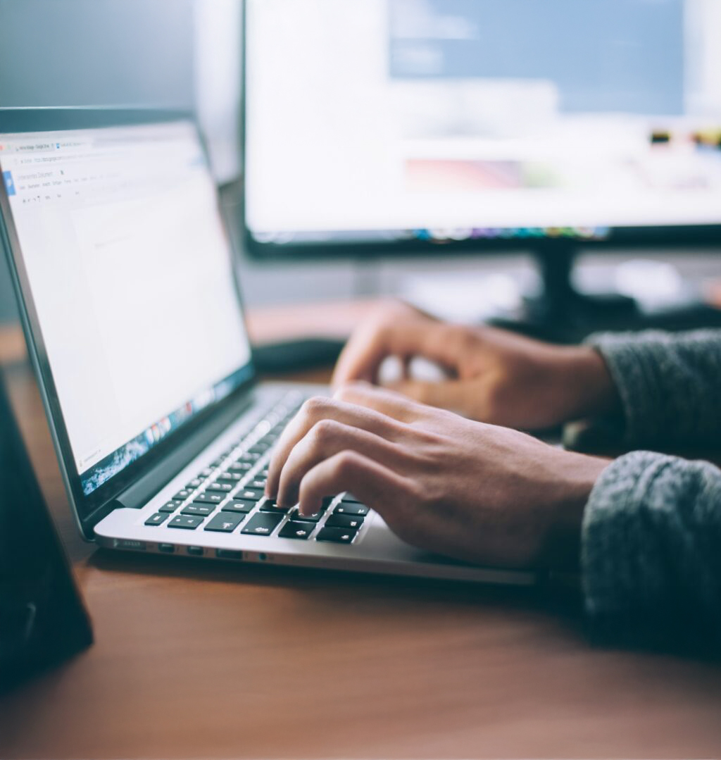 Professional working on laptop developing SAP BTP strategy and enterprise solutions at modern office desk